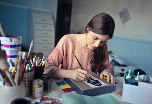 Female artist deeply engaged in painting at her creative studio workspace.