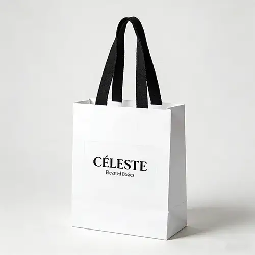White cardstock bag with black ribbon handle and black logo